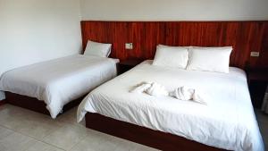 Giường trong phòng chung tại Phouluang Hotel