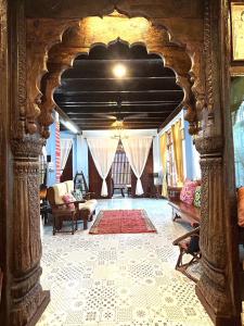 a living room with an archway in a building at บ้านมาดามกรีน Baan Madamn Green Nan in Nan