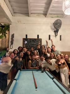 a group of people posing next to a pool table at The Hostel Canggu in Canggu