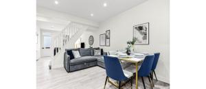 a living room with a table and a couch at City Elegance: Spacious 2BR for Urban Comfort in Twickenham