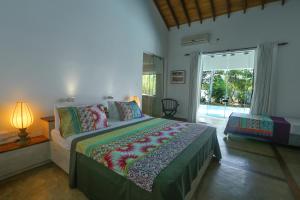 a bedroom with a large bed and a large window at Villa Hundira in Negombo +57 photos