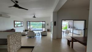 a living room with a couch and a table at Longview - stunning views, sleeps 7 in Port Vila