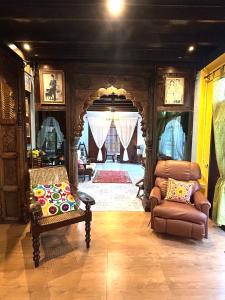 a living room with a couch and a chair at บ้านมาดามกรีน Baan Madamn Green Nan in Nan