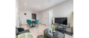 a living room with a couch and a table at Harmonious Greens: Cozy 1-Bed Flat in Harrow in Harrow