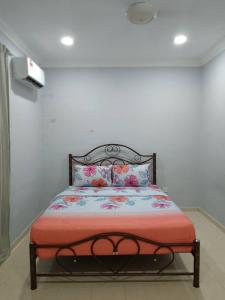 ein Schlafzimmer mit einem Bett mit einer roten Decke in der Unterkunft Cempaka Homestay Batu Pahat 93 in Batu Pahat