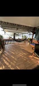 a wooden deck with a bridge with benches on it at Haad Salad Villa in Salad Beach
