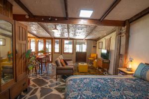 a bedroom with a bed and a living room at Gardenhouse on George in Burra