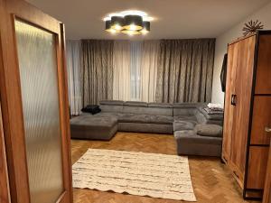 a living room with a sectional couch and a living room with at Luxus Apartment in Center Dusseldorf - 2 Rooms in Düsseldorf