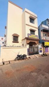 a motorcycle parked in front of a building at Goroomgo New Sriyansh Puri in Puri
