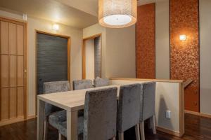 a dining room with a table and chairs at RESI STAY Fuyacho in Kyoto
