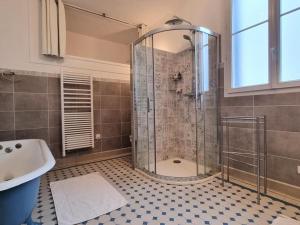 a bathroom with a shower with a tub and a sink at Maison de meulière près de Paris avec jardin, cheminée et tout confort inclus - FR-1-527-45 in Carrières-sur-Seine +27 photos