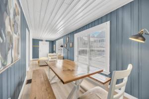 a dining room with blue walls and a wooden table at Night Lights at De Haven in St. Augustine