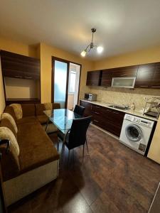 a living room with a couch and a glass table at KK Apartments in Stara Zagora