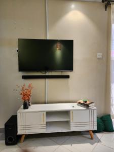 a living room with a tv on the wall at Wanderlust Haven in Thika