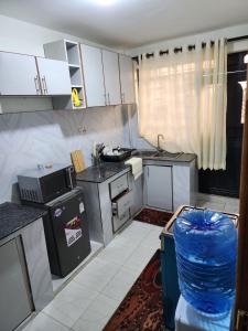 a small kitchen with a sink and a stove at Wanderlust Haven in Thika