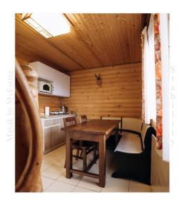 - une cuisine avec une table et des chaises dans une cabine dans l'établissement Mayak Chalet Resort Mykulychyn, à Mykulychyn