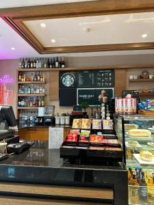 a bakery with a counter with different types of food at Ramada By Wyndham İstanbul Taksim in Istanbul