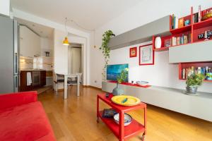 a living room with a red couch and a red table at appartamento a 500 metri da San Siro in Milan