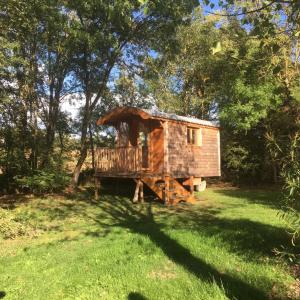 a tree house in the middle of a field at Camping La Capelle in Saint-Martin-Lalande