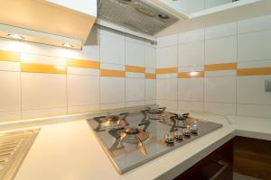 a kitchen with a stove top in a kitchen at appartamento a 500 metri da San Siro in Milan +28 photos