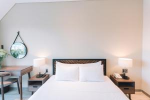 מיטה או מיטות בחדר ב-Canary Dalat Hotel