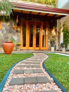a walkway in front of a house with a door at Breeze Bay Villa in Dickwella