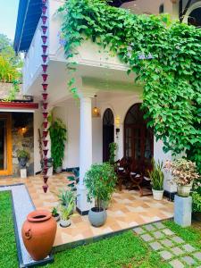 a house with a patio with plants on it at Breeze Bay Villa in Dickwella