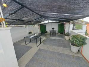 a patio with a table and some plants on it at Arthur Private Resort in Legazpi