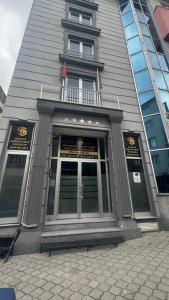a building with a door with a flag above it at Balıkesir karesi grup konaklama ve pansiyon in Balıkesir
