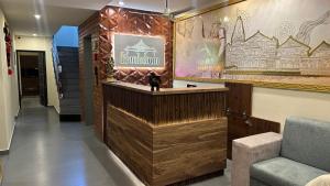 a hotel lobby with a reception counter and a chair at Kovilakam Achutham in Guruvāyūr