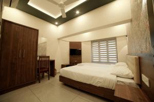 Un pat sau paturi într-o cameră la Kovilakam Achutham