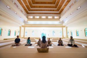a group of people sitting in a room in a church at Art of Living Retreat Center - All Inclusive - Mountain Top Wellness Retreat in Boone