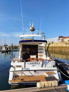 a boat docked at a dock in the water at Hotel Boat Cardeli in Gijón