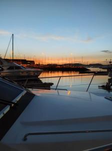 a group of boats docked in a marina at sunset at Hotel Boat Cardeli in Gijón