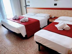 Postel nebo postele na pokoji v ubytování Ben Hur Rimini