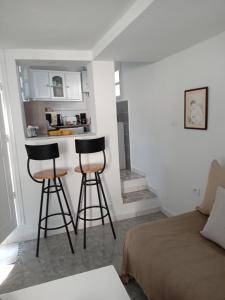 two bar stools in a room with a bed at Maison à Sidi Bou Said in Sidi Bou Saïd