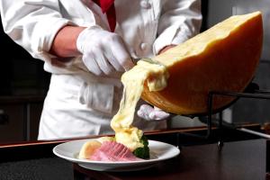 a chef is preparing a piece of food on a plate at Noboribetsu Grand Hotel in Noboribetsu