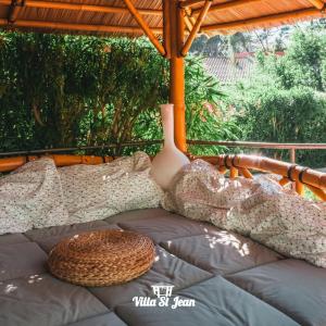 a person laying on a bed in a tent at Villa Mas de la Mer in La Ciotat