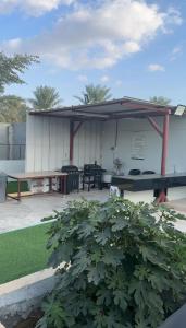 a pavilion with a picnic table and a bench at Alzam Residency in Nizwa