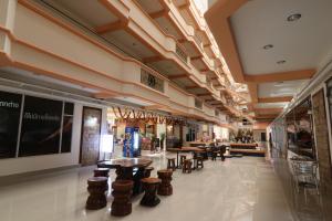 a lobby with tables and chairs in a store at Wangburapa Grand Hat Yai in Hat Yai