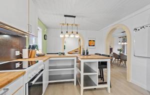 a kitchen with a counter and a dining room at Nice Home In Oksbl With Kitchen in Oksbøl