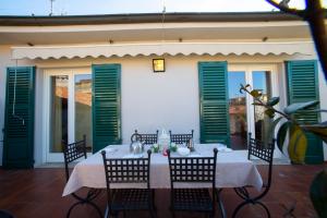 a table on a patio with green shutters at DIMORA STORICA VICOLO DEL VOLTO in Iseo