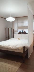 a bedroom with a large white bed with a canopy at Our moment #EuropeAirbnbmood#freeparking#cafebathroom#simmons#max4 in Daejeon
