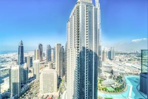 a view of a large city with tall buildings at Downtown Luxury - Stunning Burj Khalifa & Sea View - 5 Minutes Walk to Dubai Mall in Dubai