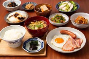 a table with plates of food and bowls of food at Sotetsu Hotels The Splaisir Yokohama in Yokohama