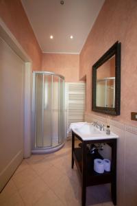 a bathroom with a shower and a sink and a mirror at DIMORA STORICA VICOLO DEL VOLTO in Iseo