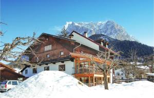 a house in the snow in front of a mountain at Nice Apartment In Ehrwald With 2 Bedrooms And Wifi in Ehrwald