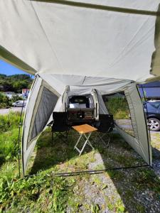 a tent with a grill inside of it at Electric London Black Minicamper in Bergen