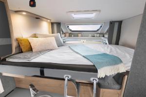 a large bed in the back of a rv at B-Happy - Deine Wohnmobilvermietung in Parey