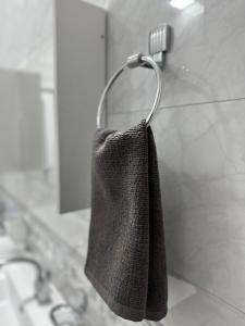a towel hanging on a towel rack in a bathroom at Sunny Hostel in Osh